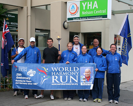 The New Zealand World Harmony Run team outside the YHA in Nelson with the YHA manager Sean Gidall