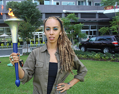 Natalie Pa’apa’a, lead singer of Blue King Brown, holding the Torch