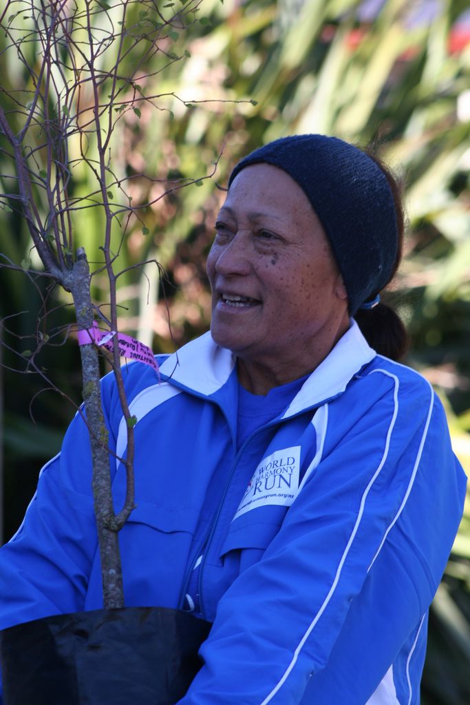 Eta carrying the World Harmony Run Tree.